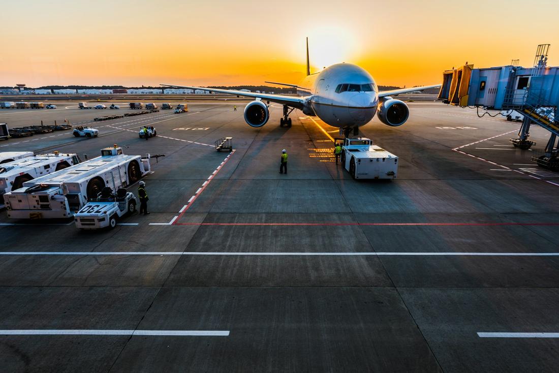 Cargo aircraft at an airport apron at sunset